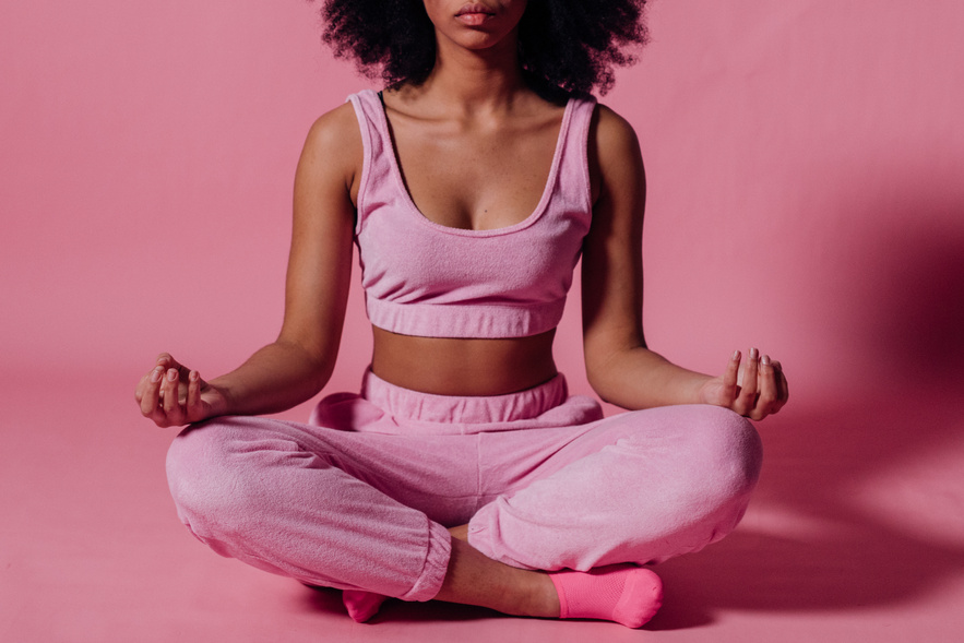 Woman in Pink Crop Top and Jogging Pants Practicing Yoga